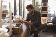 © Wavebreak Media - Man using mobile phone while having cup of coffee