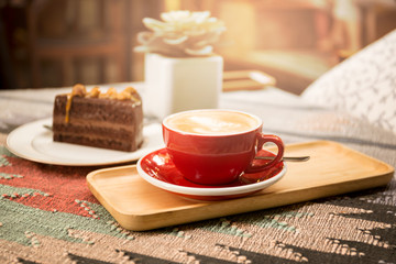 Wall Mural - Cup of coffee and piece of macadamia chocolate cake