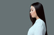 © LIGHTFIELD STUDIOS - profile portrait of beautiful young asian woman standing isolated on grey
