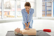 © Africa Studio - Young woman practicing first aid on mannequin indoors