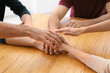 © Africa Studio - People putting hands together, closeup. Unity concept