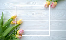 Lovely Tulip Flowers On White Wooden Background With Frame, Holiday Postcard For Women's Day Or Mother's Day Or Sale Concept. Floral Spring Background With Copy Space. Flat Lay.