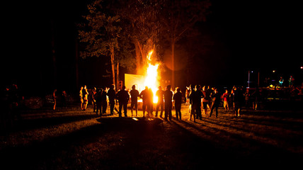 big party at camp fire at night