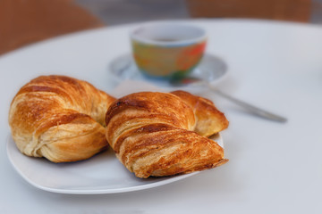 two sweet rolls on a plate closeup as background