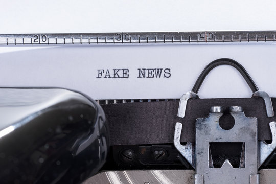 Black text Fake News written on an old typewriter