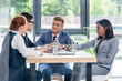 © LIGHTFIELD STUDIOS - Behind the glass view of executives discussing project in modern office