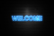 © zobaair - Welcome neon Sign on brickwall