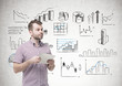 © ImageFlow - Bearded young man holding paper, infographics