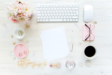 Workspace with, computer, paper blank, bouquet chrysanthemum. Women's fashion accessories isolated on white wooden background. Flat composition for magazines, websites, media. Flat lay, top view