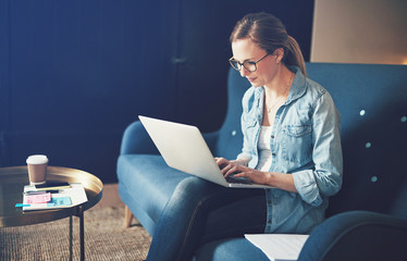 Smiling female entrepreneur working from home using a laptop