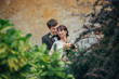 © VAKSMANV - Happy bride and groom at a park on their wedding day