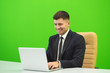 © realstock1 - The happy man works with the laptop on the green background