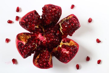 Wall Mural - Cut pomegranate on a white background