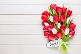 Fototapeta Tulipany - Springt time. Red tulip bouquet on the white wooden background.