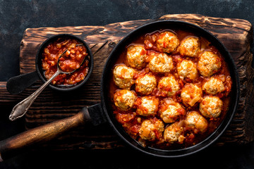 Wall Mural - Homemade meatballs stewed in tomato sauce in cast iron pan