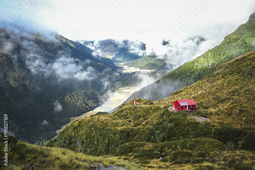 Fotografiet Liverpool Hut sits on the edge of a large cliff in the Matukituki Valley in Mt