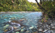 The blue-green water of the Toaroha River is seen smoothed out in this long exposure shot taken near Cedar Flat Hut on New Zealand's south island.