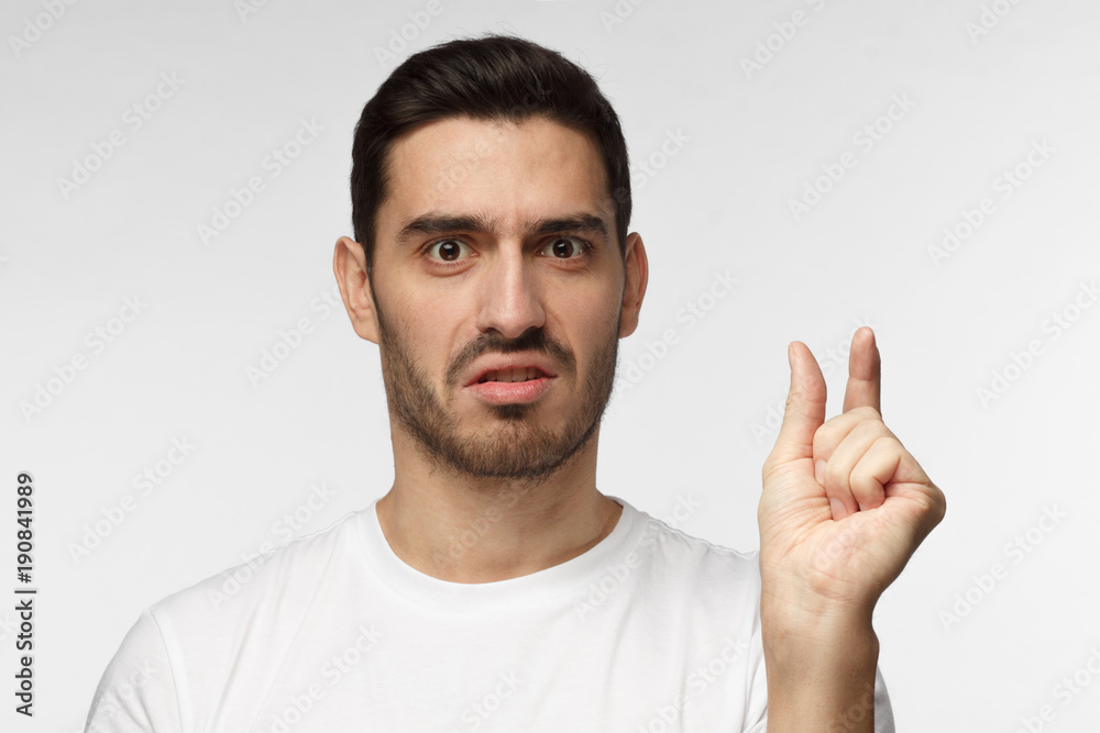 Man Small Resolution So tiny! Young man in white tshirt, gesticulates with hands, showing ...