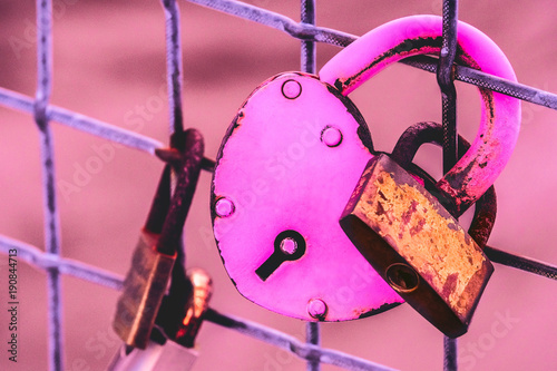 Fotografia, Obraz A pink heart-shaped love lock with baby lock