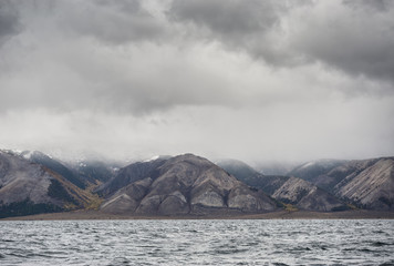 Wall Mural - stern the shore of lake Baikal in the autumn and the grey storm 