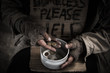 Homeless hands hold the bowl and count money inside