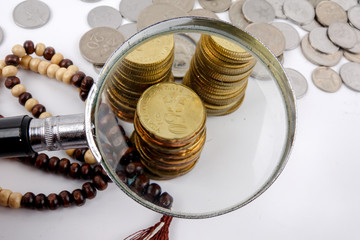 Wall Mural - Rosary and coins. Islamic Banking/Finance concept.