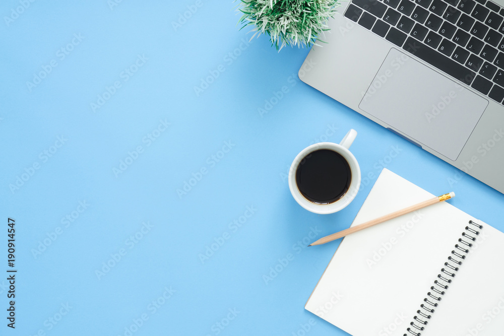 Minimal work space - Creative flat lay photo of workspace desk. Top view office desk with laptop, notebooks and coffee cup on blue color background. Top view with copy space, flat lay photography. - obrazy, fototapety, plakaty 