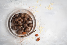 Vanilla-chocolate Raw Vegan Sweet Balls With Nuts, Dates And Cocoa. Healthy Vegan Food Concept. Gray Background, Top View, Copy Space