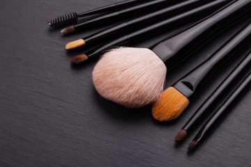 make-up brushes on grey background