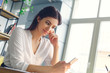 © Viktoriia - Pregnant business woman working at office motherhood sitting using smartphone