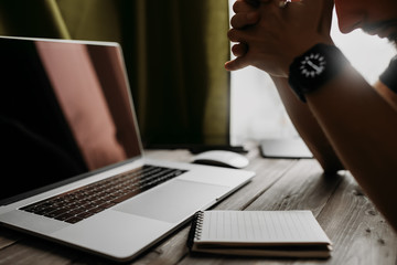 Fototapete - Man is writing on draft notepad and using laptop computer and at home office. Freelance lifestyle workplace