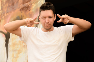 A man stands in the aisle and directs towards the camera folded fingers with a fork