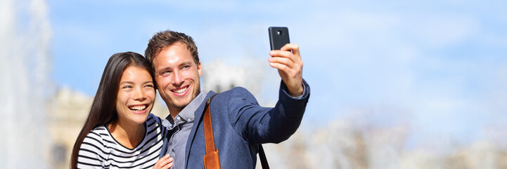 Wall Mural - happy multiracial couple taking selfie photo with phone on spring travel holiday. europe vacation tr