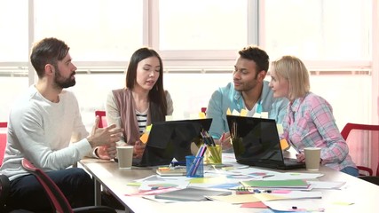 Group of multiethnic busy people working in an office. Mixed race team of young business people working together.