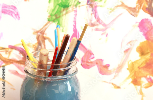 Fotografie, Obraz Paint brushes soaking in a glass jar of soapy water