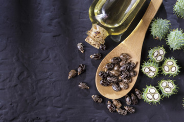 beans and castor oil on the black table