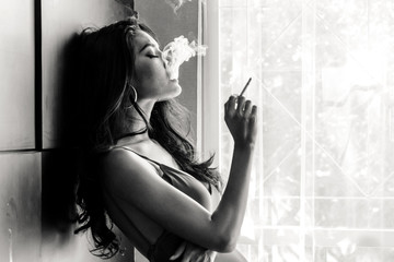 Fashion portrait of  beautiful woman sexy slim body smoking cigarette