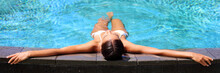 Luxury Resort Woman Relaxing In Infinity Swim Pool. Asian Young Adult Lying Down In Swimming Pool Of Beach Resort For Summer Holidays Or Travel Vacations Banner.