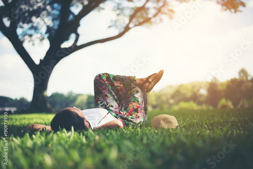 Fotografie, Obraz Young woman lying down on grass. relax time.