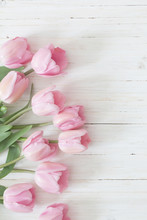Beautiful Pink Tulips On White Wooden Background