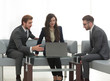 © ASDF - Confident business team working in an office.