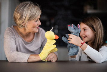 A small girl and grandmother playing at home.