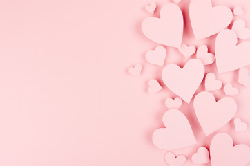paper pink hearts fly on soft pink color background, border, copy space. valentine day concept for d
