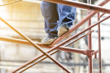 Wall Mural - Industrial worker labourer on scaffolding, construction site.