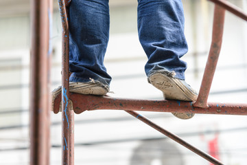 Wall Mural - Industrial worker labourer on scaffolding, construction site.