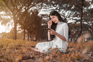 Sticker - sad woman calling on mobile phone in park