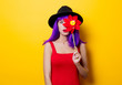 hipster girl with purple hairstyle with pinwheel