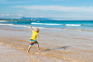 Wall Mural - Child on tropical beach. Sea vacation with kids.