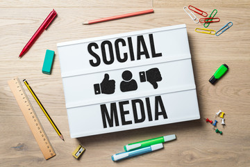 Wall Mural - social media written on lightbox in office as flatlay