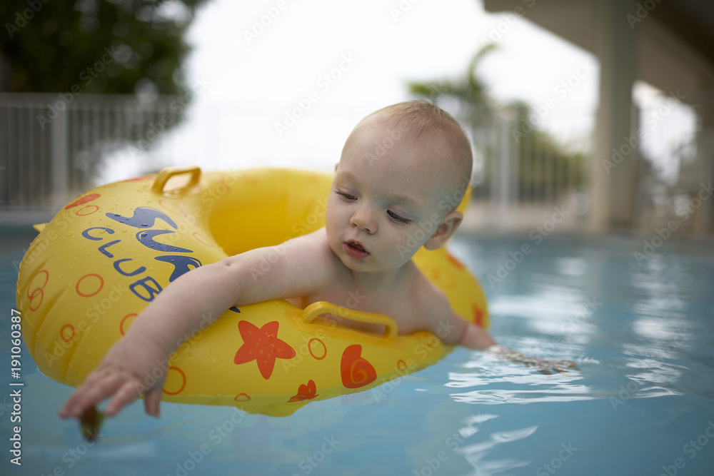 Boy in inflatable in swimming pool Stock Photo | Adobe Stock